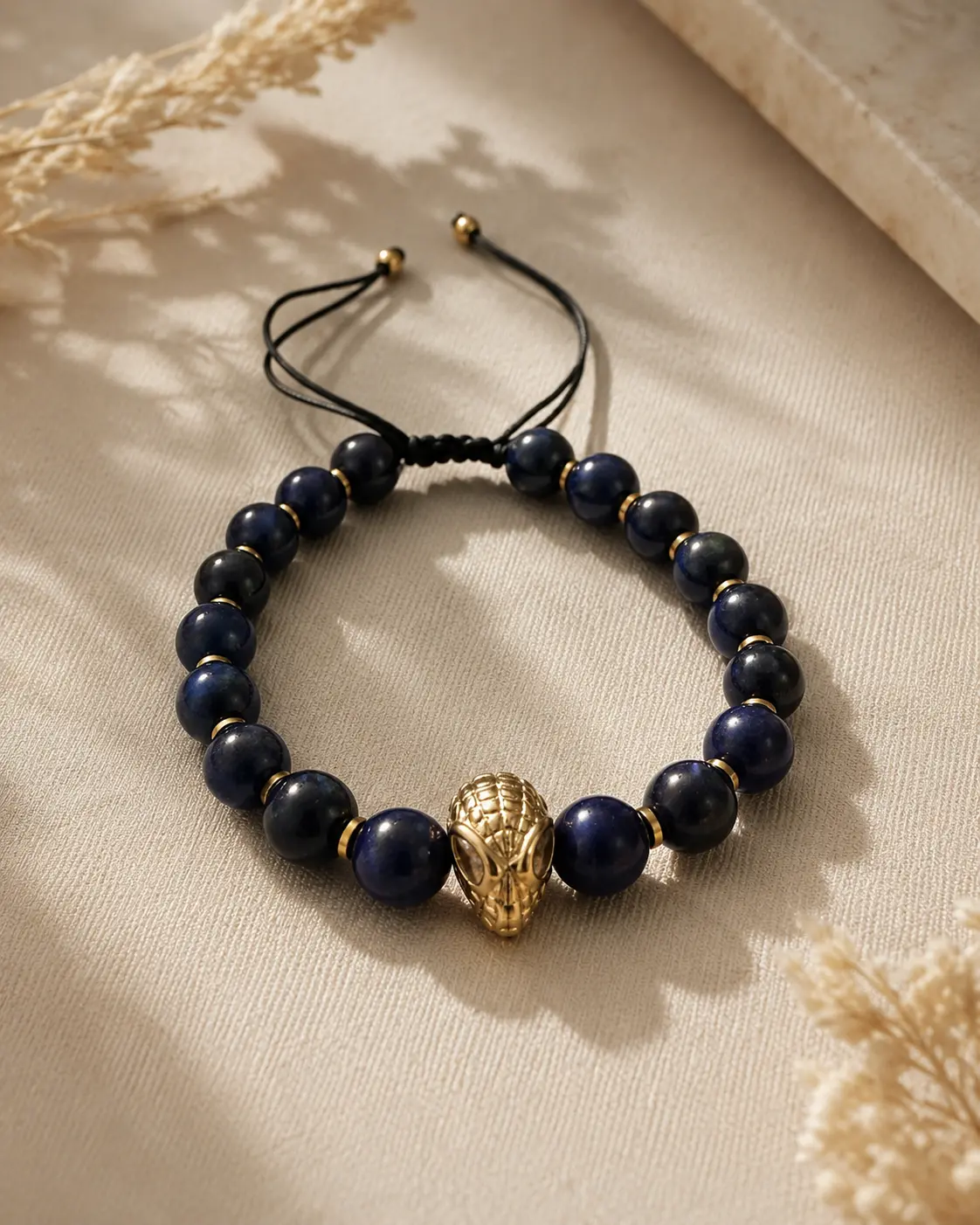 Lapis Lazuli Stone Bracelet with Gold Spider-Man Handmade Lapis Lazuli Stone Bracelet featuring deep blue gemstone beads and a gold Spider-Man charm design.