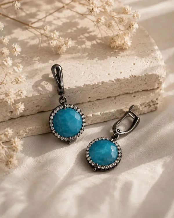 The Gem Stories Azure Earrings featuring elegant blue gemstones in a handcrafted drop design.